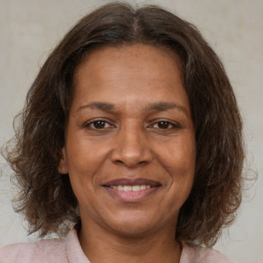 Joyful white adult female with medium  brown hair and brown eyes