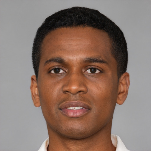 Joyful black young-adult male with short  brown hair and brown eyes
