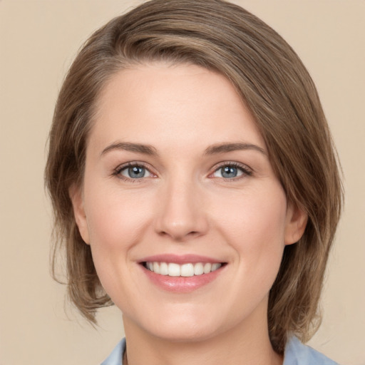 Joyful white young-adult female with medium  brown hair and grey eyes