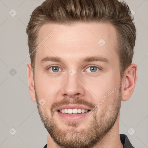 Joyful white young-adult male with short  brown hair and grey eyes