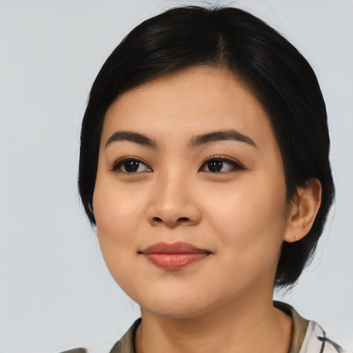 Joyful asian young-adult female with medium  black hair and brown eyes