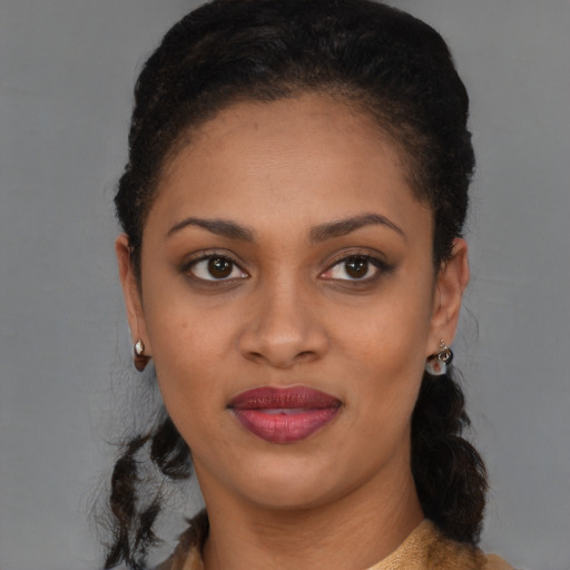 Joyful black young-adult female with medium  brown hair and brown eyes