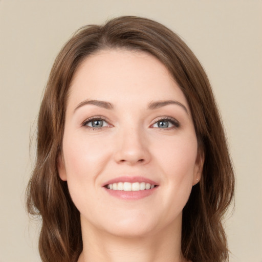 Joyful white young-adult female with long  brown hair and green eyes