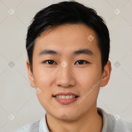 Joyful asian young-adult male with short  black hair and brown eyes