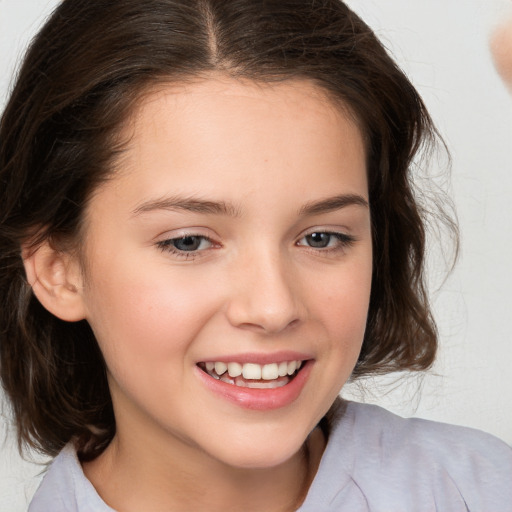 Joyful white child female with medium  brown hair and brown eyes