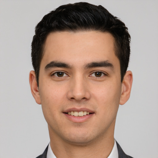 Joyful white young-adult male with short  black hair and brown eyes