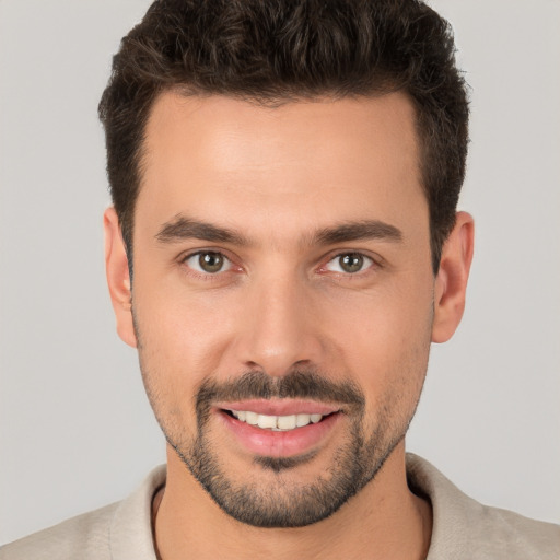 Joyful white young-adult male with short  brown hair and brown eyes