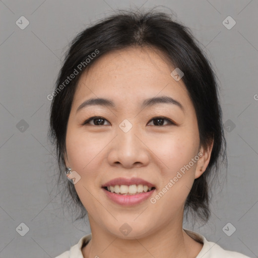 Joyful asian young-adult female with medium  black hair and brown eyes