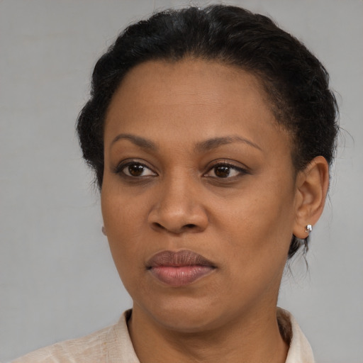 Joyful black adult female with short  brown hair and brown eyes