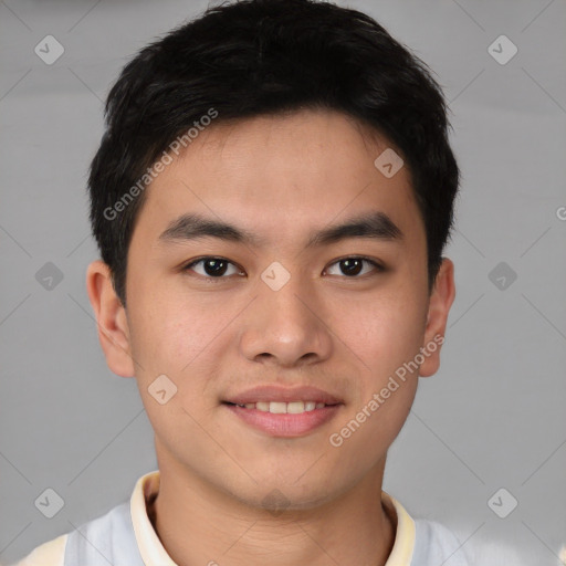 Joyful asian young-adult male with short  brown hair and brown eyes