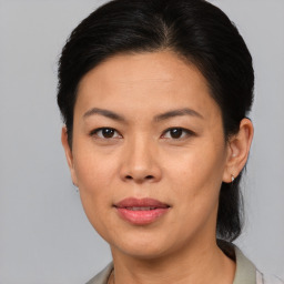 Joyful asian adult female with medium  brown hair and brown eyes