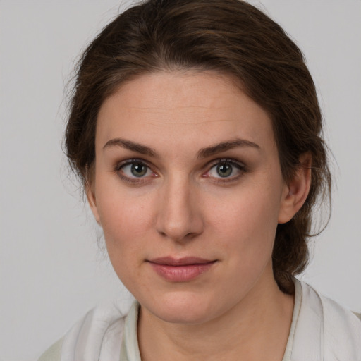 Joyful white young-adult female with medium  brown hair and grey eyes