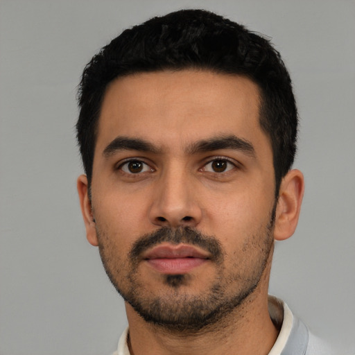 Neutral latino young-adult male with short  black hair and brown eyes