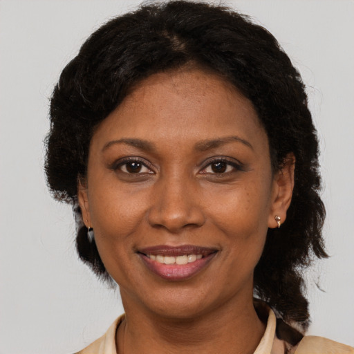 Joyful black adult female with short  brown hair and brown eyes