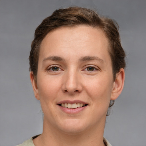 Joyful white young-adult female with short  brown hair and brown eyes