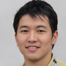 Joyful asian young-adult male with short  black hair and brown eyes