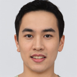 Joyful asian young-adult male with short  black hair and brown eyes