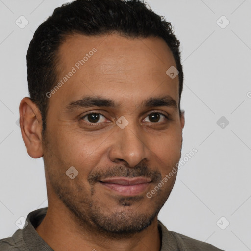 Joyful latino young-adult male with short  brown hair and brown eyes