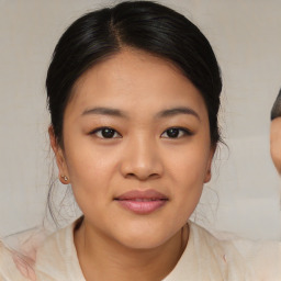 Joyful asian young-adult female with medium  brown hair and brown eyes