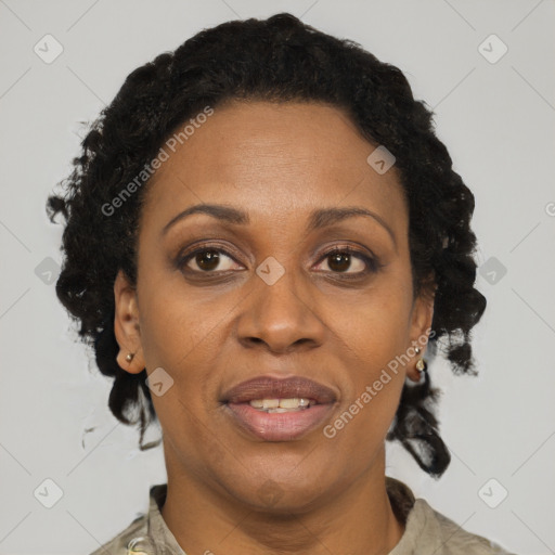 Joyful black adult female with short  black hair and brown eyes