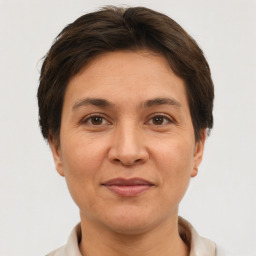 Joyful white adult female with short  brown hair and brown eyes