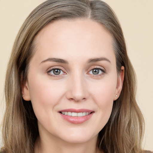 Joyful white young-adult female with long  brown hair and grey eyes