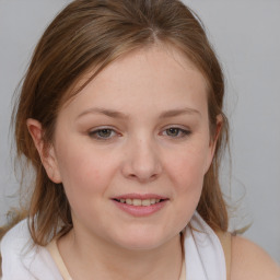 Joyful white young-adult female with medium  brown hair and blue eyes