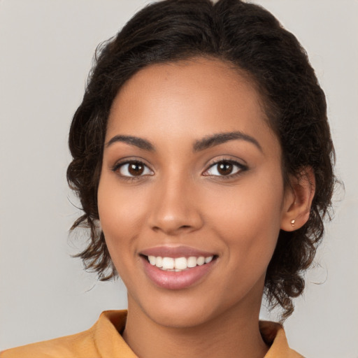 Joyful latino young-adult female with long  brown hair and brown eyes