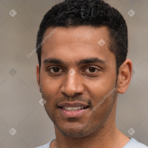 Joyful black young-adult male with short  black hair and brown eyes