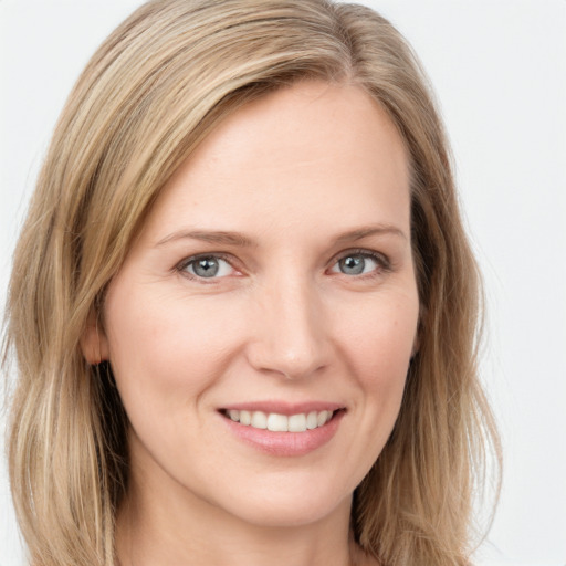 Joyful white young-adult female with long  brown hair and green eyes