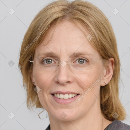 Joyful white adult female with medium  brown hair and blue eyes