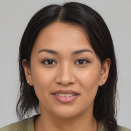 Joyful latino young-adult female with medium  brown hair and brown eyes