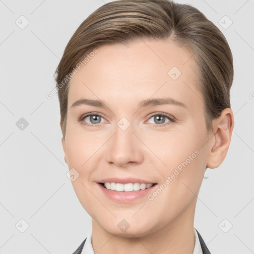 Joyful white young-adult female with medium  brown hair and grey eyes