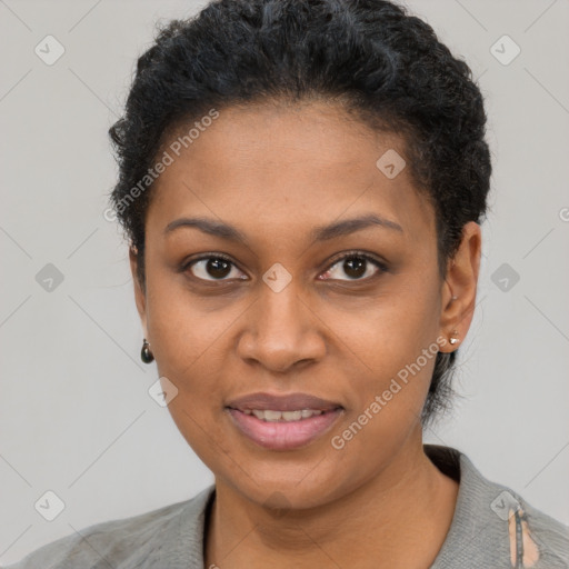 Joyful black young-adult female with short  black hair and brown eyes