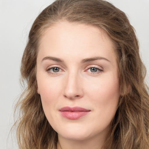 Joyful white young-adult female with long  brown hair and green eyes