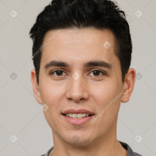 Joyful white young-adult male with short  black hair and brown eyes