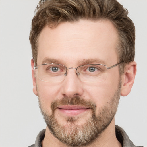 Joyful white adult male with short  brown hair and grey eyes