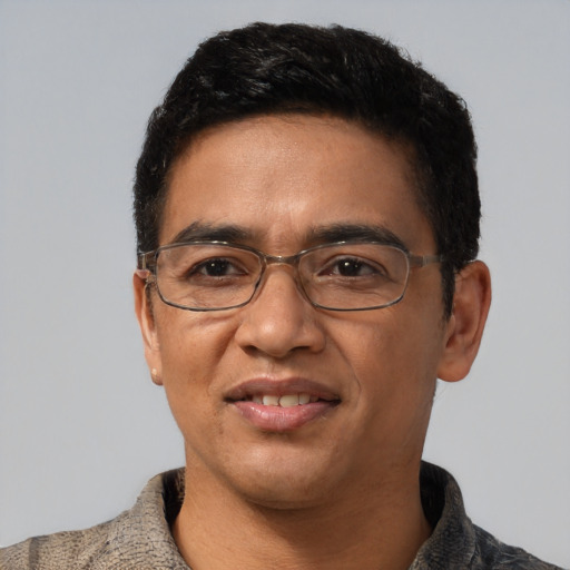 Joyful asian adult male with short  black hair and brown eyes