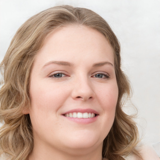 Joyful white young-adult female with medium  brown hair and blue eyes