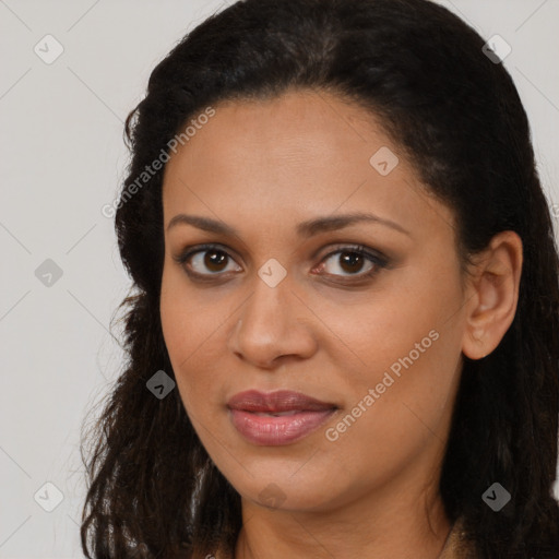 Joyful black young-adult female with long  brown hair and brown eyes