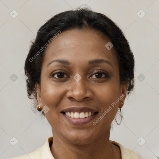 Joyful black adult female with medium  brown hair and brown eyes