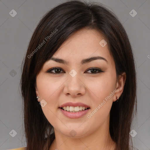 Joyful asian young-adult female with long  brown hair and brown eyes