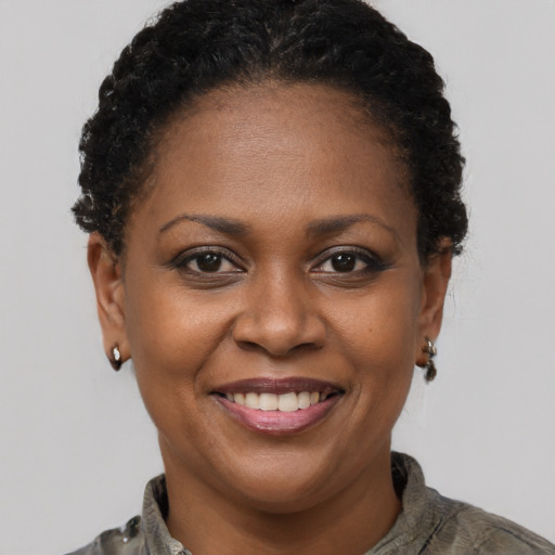 Joyful black adult female with short  brown hair and brown eyes