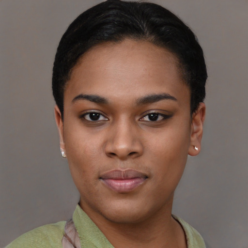 Joyful latino young-adult female with short  black hair and brown eyes