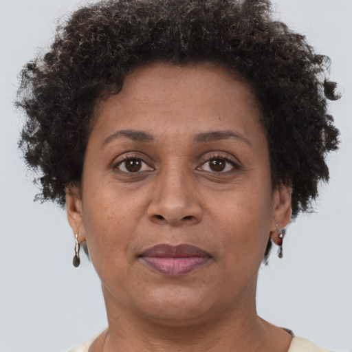 Joyful black adult female with short  brown hair and brown eyes