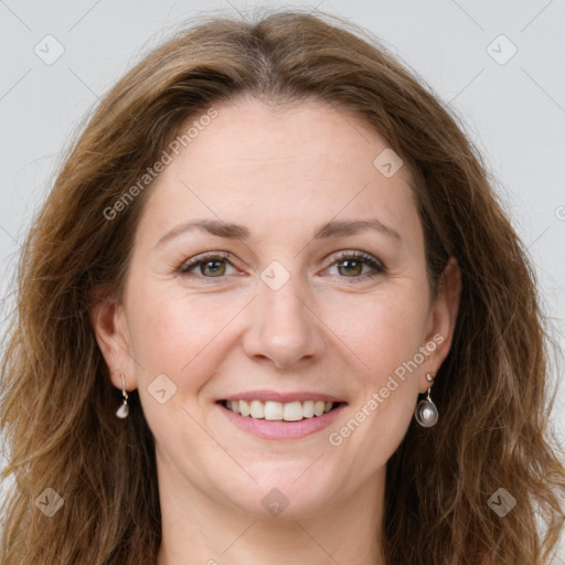 Joyful white adult female with long  brown hair and green eyes