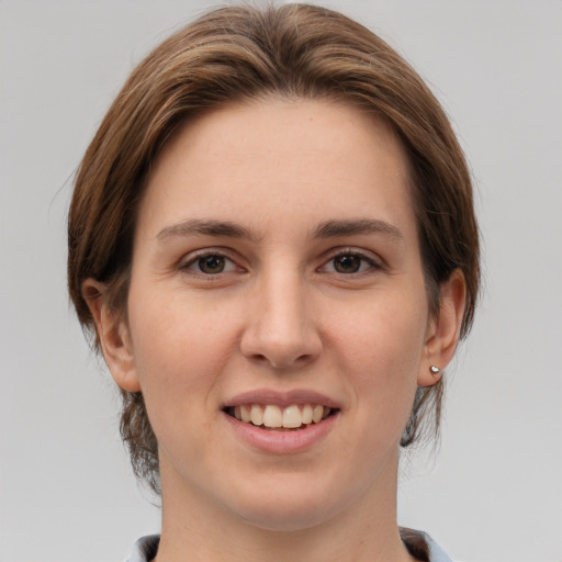 Joyful white young-adult female with medium  brown hair and brown eyes