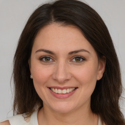 Joyful white young-adult female with medium  brown hair and brown eyes