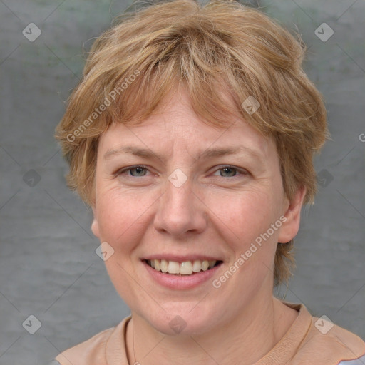 Joyful white adult female with medium  brown hair and blue eyes