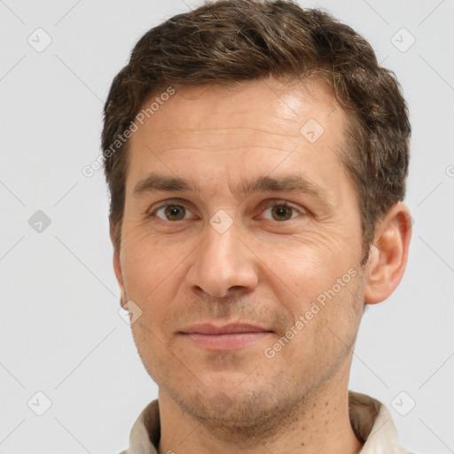 Joyful white adult male with short  brown hair and brown eyes